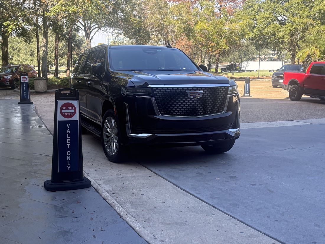 Black Cadillac Escalade at a charging station